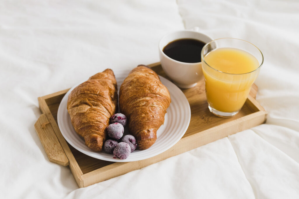 high-angle-tray-with-croissants-orange-juice-coffee